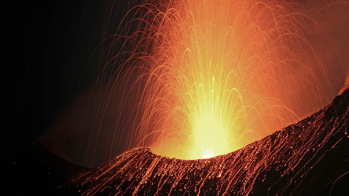 Night shot of an erupting volcano raising the question what threat from the debt mountain we have to expect