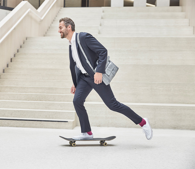 About Vontobel: A businessman rides a skateboard